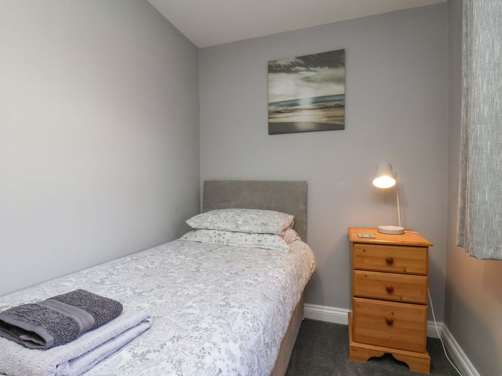 A bedroom with a bed and nightstand at Heather Croft in Robin Hood's Bay