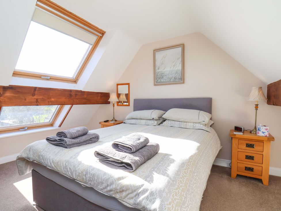 A bedroom with a bed and nightstand at Heather Croft in Robin Hood's Bay