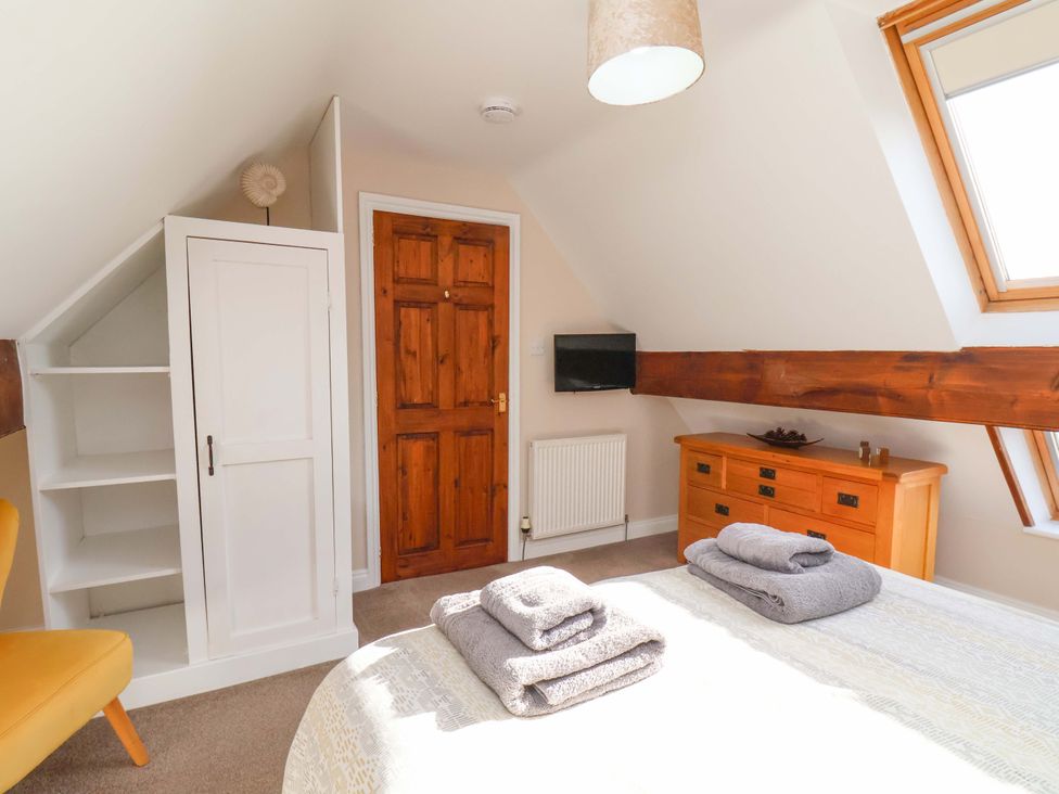 A bedroom with a bed and storage furniture at Heather Croft in Robin Hood's Bay