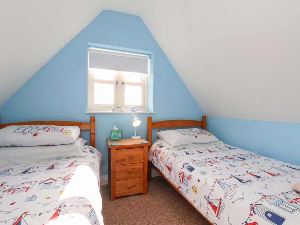 A bedroom with two beds and a nightstand at Heather Croft in Robin Hood's Bay