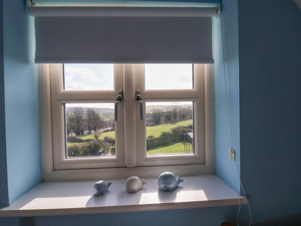 A window with whale figurines on the sill at Heather Croft in Robin Hood's Bay