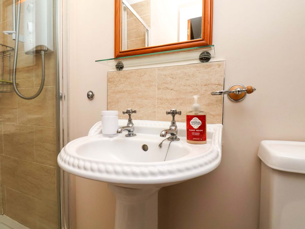 A bathroom with a wash basin and hand wash at Heather Croft in Robin Hood's Bay