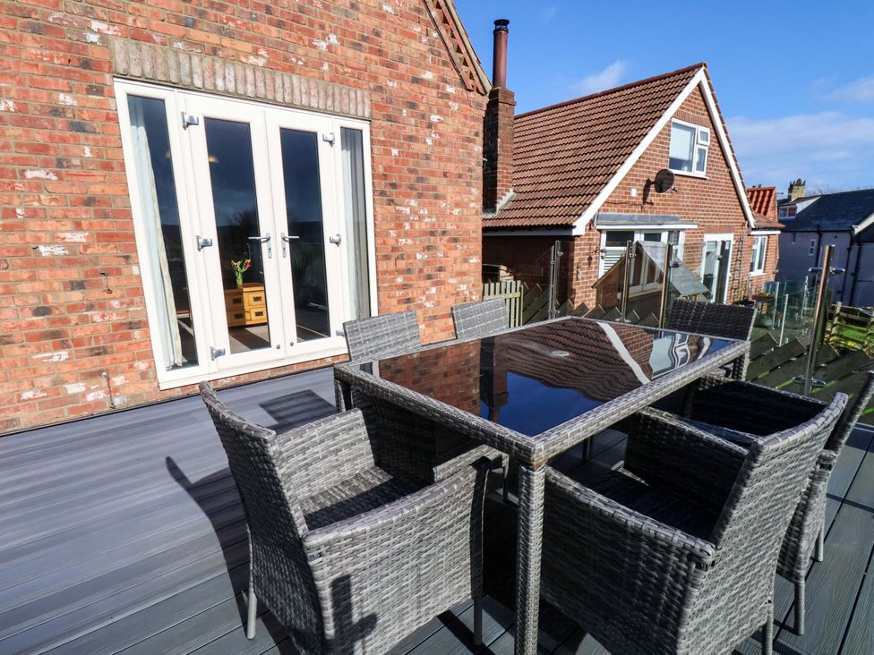 A patio with a table and chairs at Heather Croft in Robin Hood's Bay