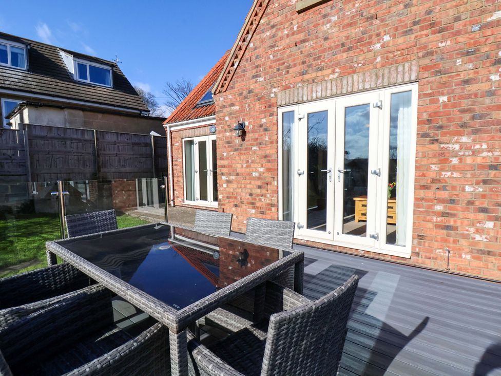 An outdoor dining area with a table and chairs at Heather Croft in Robin Hood's Bay