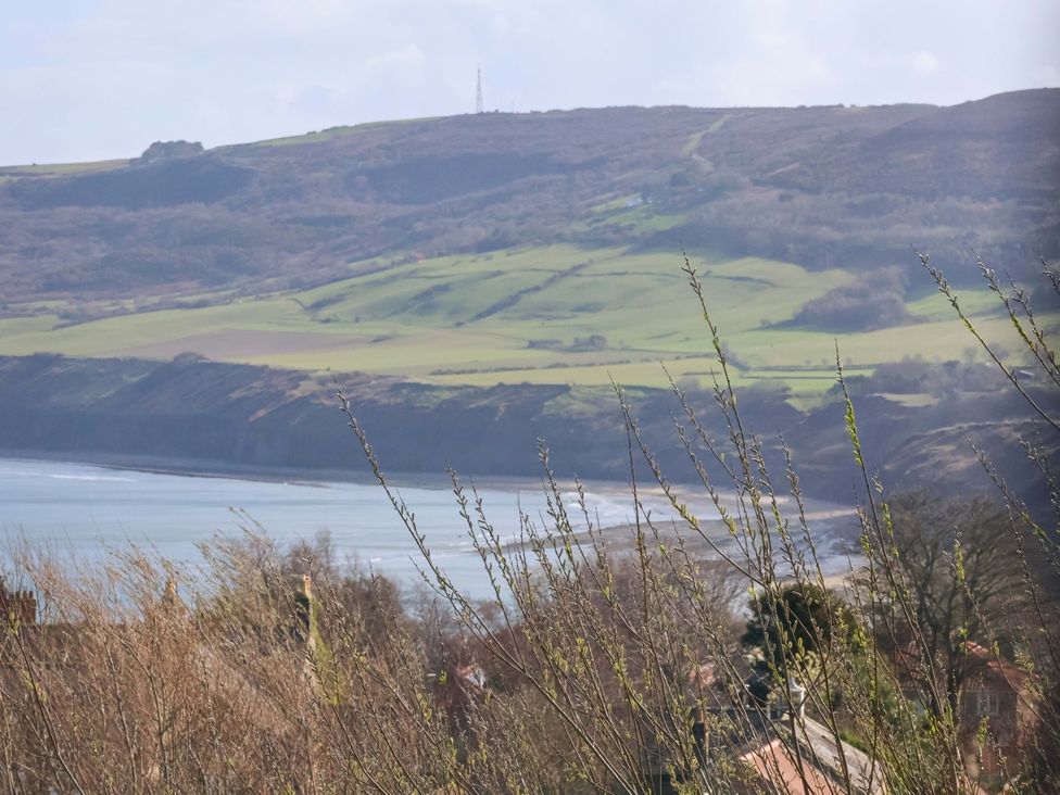 A view of a coastline with sea and hills at Heather Croft in Robin Hood's Bay