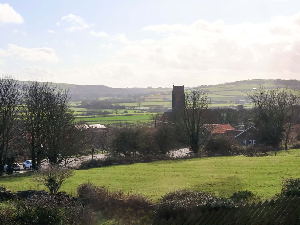 A view of fields and a church at Heather Croft in Robin Hood's Bay