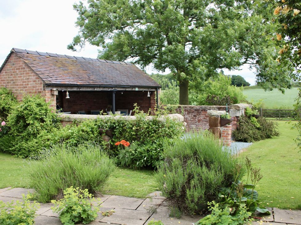 A garden with a shed and plants at Lake View Cottage in Audley Brow near Market Drayton