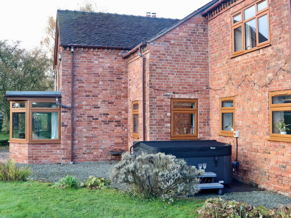 An outdoor area with a hot tub and plants at Lake View Cottage in Audley Brow near Market Drayton