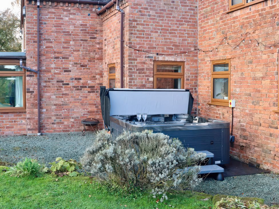 A hot tub in an outdoor area at Lake View Cottage Audley Brow near Market Drayton