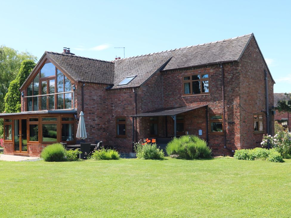 An exterior view of a house with a garden at Lake View Cottage Audley Brow near Market Drayton