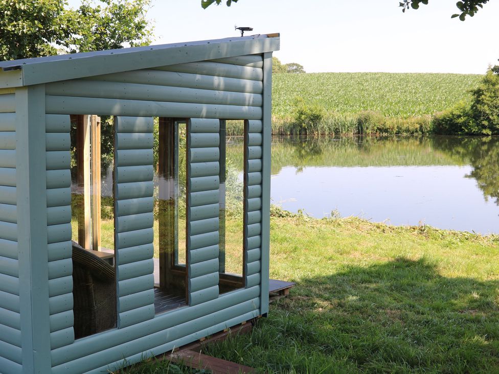 A cabin overlooking a lake at Lake View Cottage Audley Brow near Market Drayton