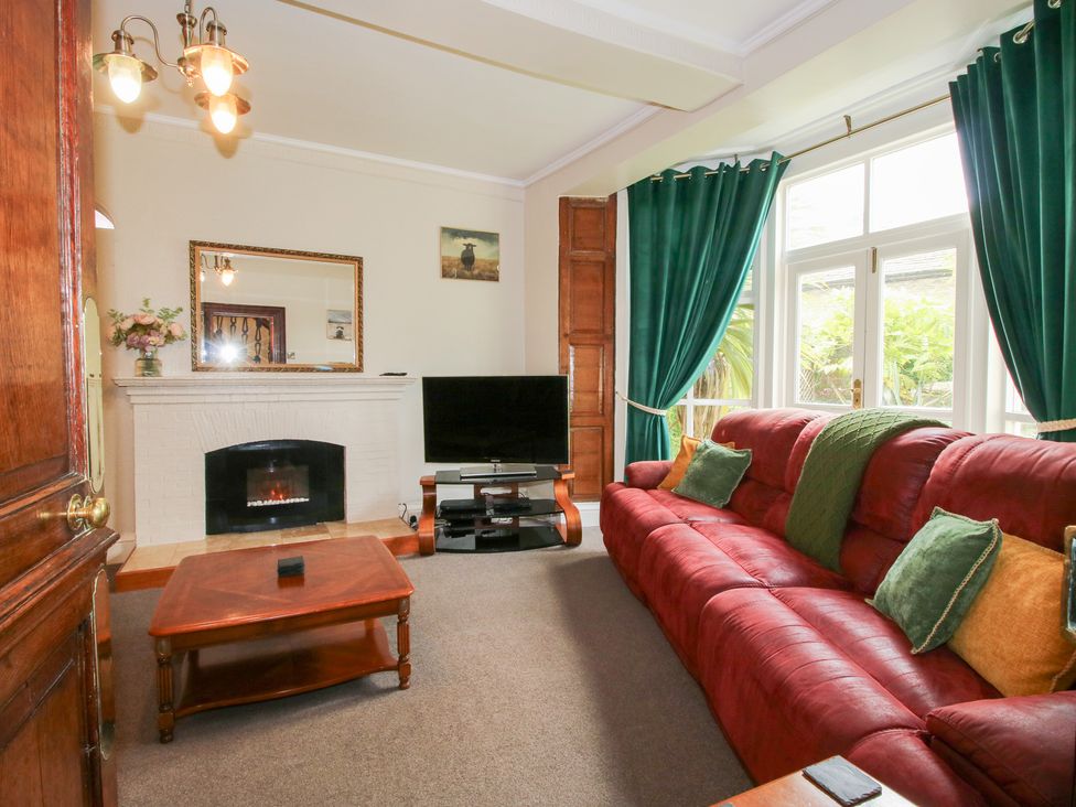 A living room with a sofa and television at The Laurels in Bishop's Castle