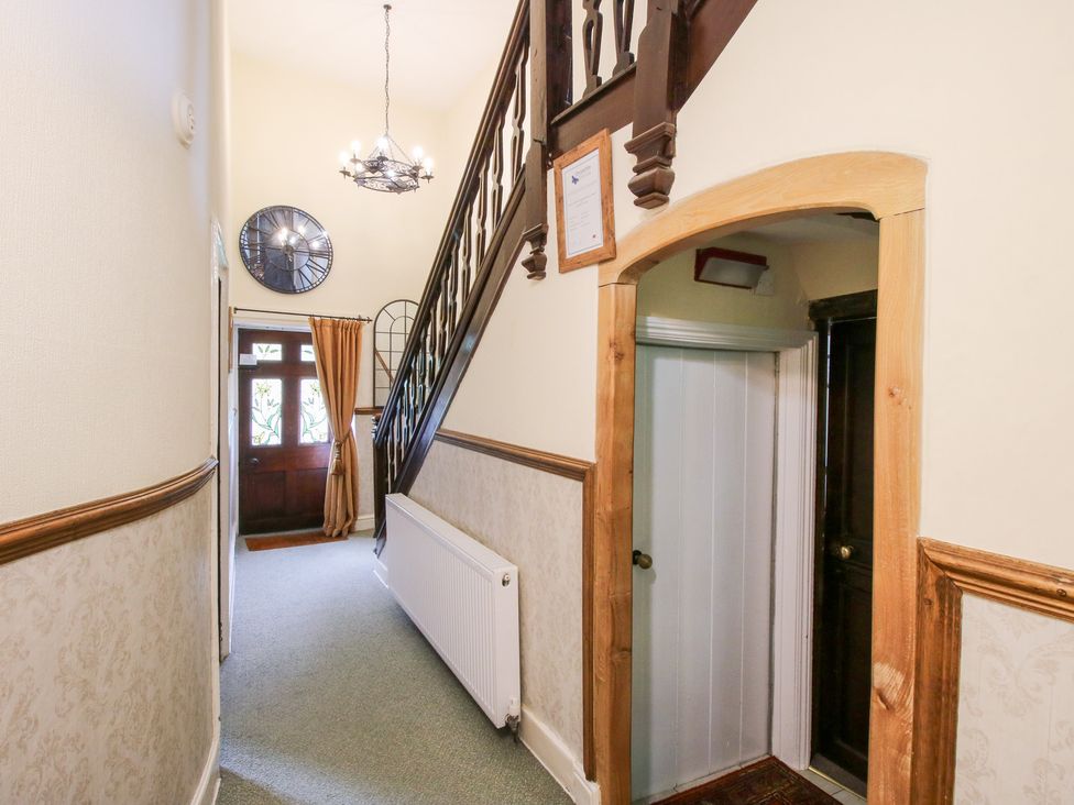 A hallway with staircase and front door at The Laurels in Bishop's Castle