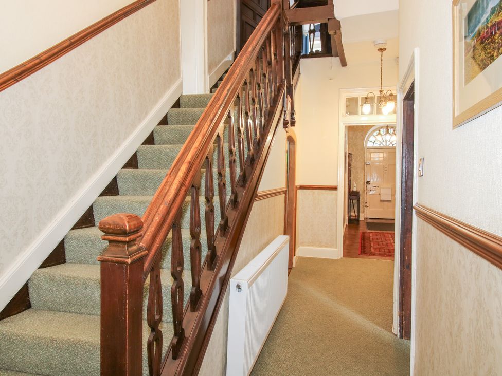 A hallway with staircase and radiator at The Laurels in Bishop's Castle