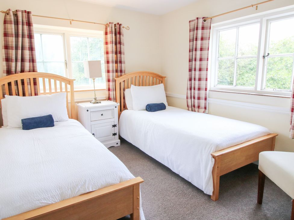 A bedroom with two single beds and a nightstand at The Laurels in Bishop's Castle