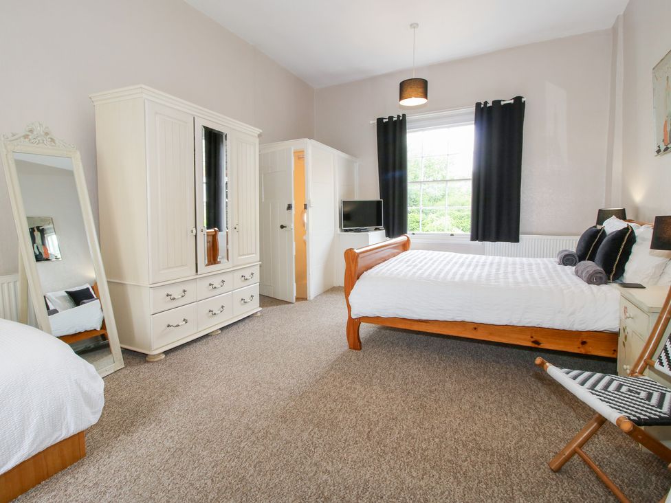 A bedroom with a bed and wardrobe at The Laurels in Bishop's Castle