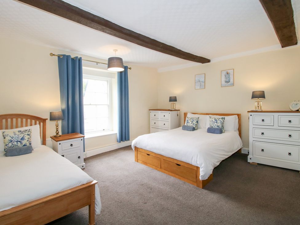 A bedroom with two beds and furniture at The Laurels in Bishop's Castle