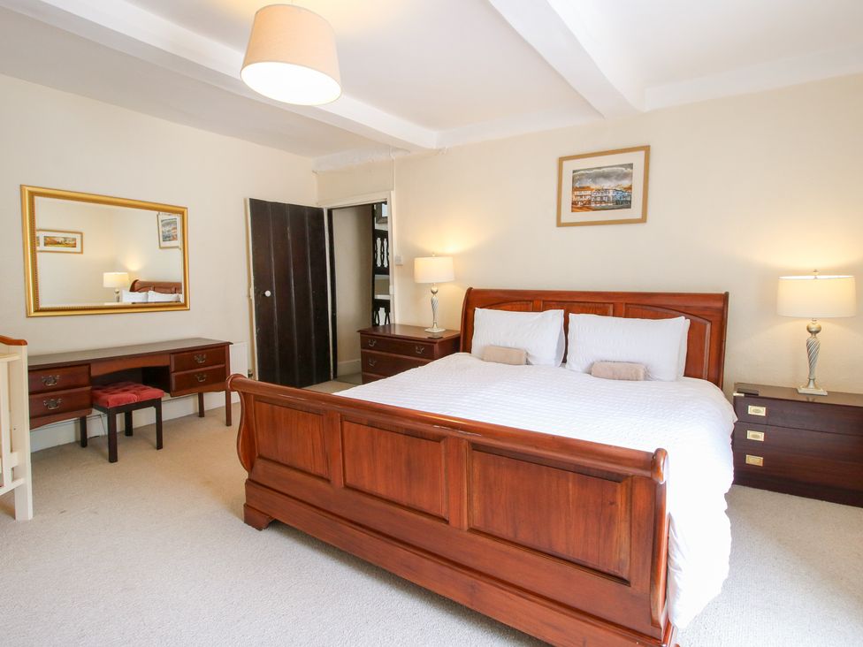 A bedroom with a bed and dresser at The Laurels in Bishop's Castle