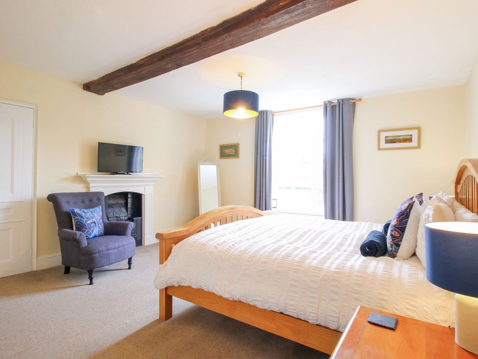 A bedroom with a bed and television at The Laurels in Bishop's Castle