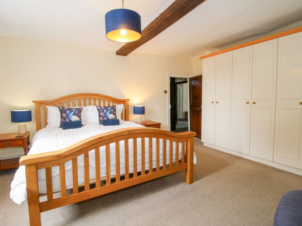 A bedroom with a bed and wardrobe at The Laurels in Bishop's Castle