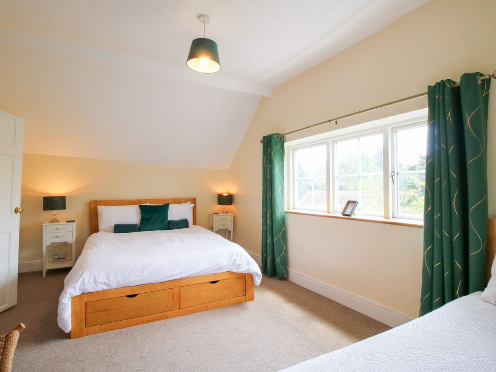 A bedroom with a bed and nightstands at The Laurels in Bishop's Castle