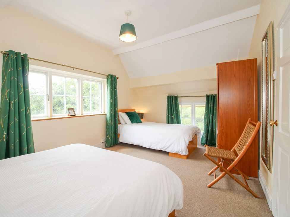 A bedroom with two beds and a window at The Laurels in Bishop's Castle