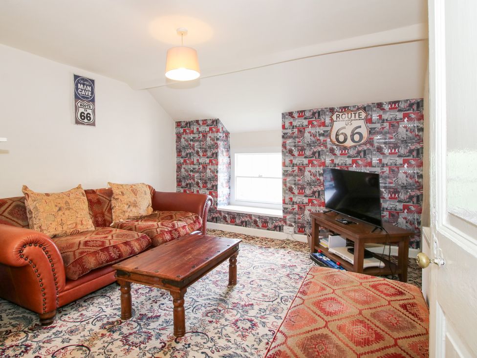 A living room with a sofa and television at The Laurels in Bishop's Castle