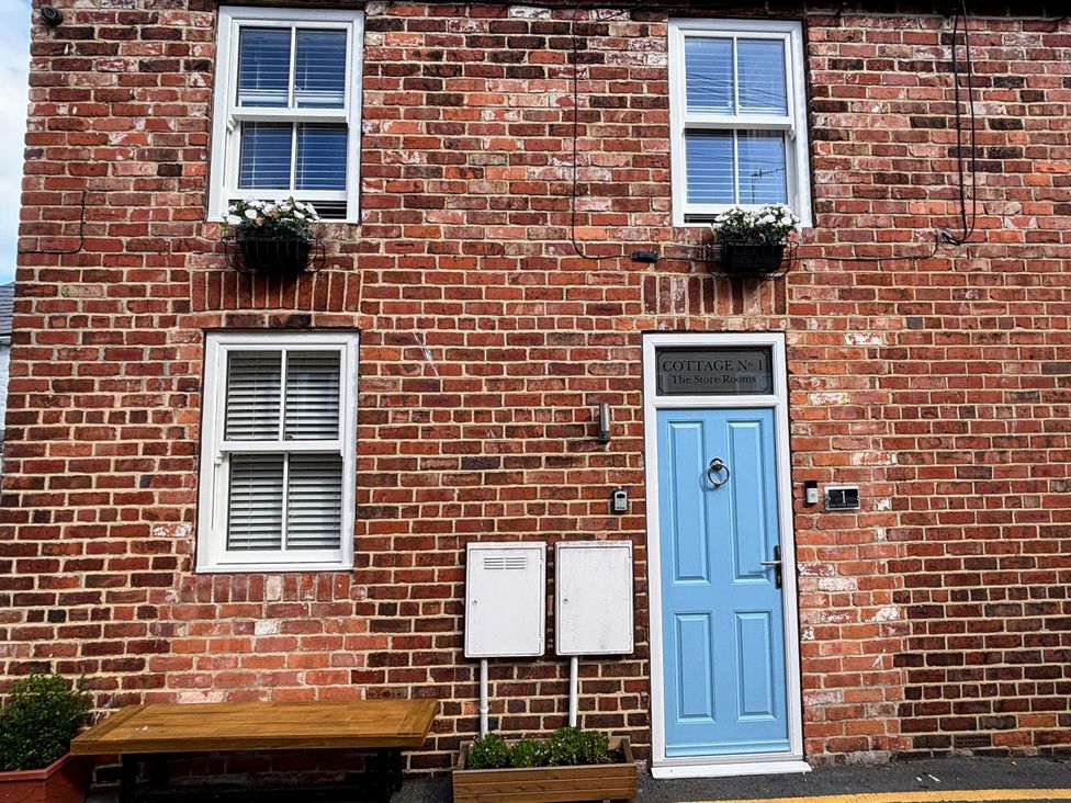 An exterior view of a cottage with a blue door at The Store Rooms in Whitby