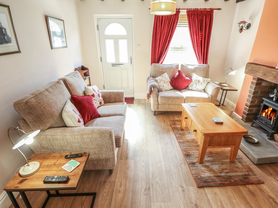 A living room with two sofas and a fireplace at 29 High Street Aldeburgh
