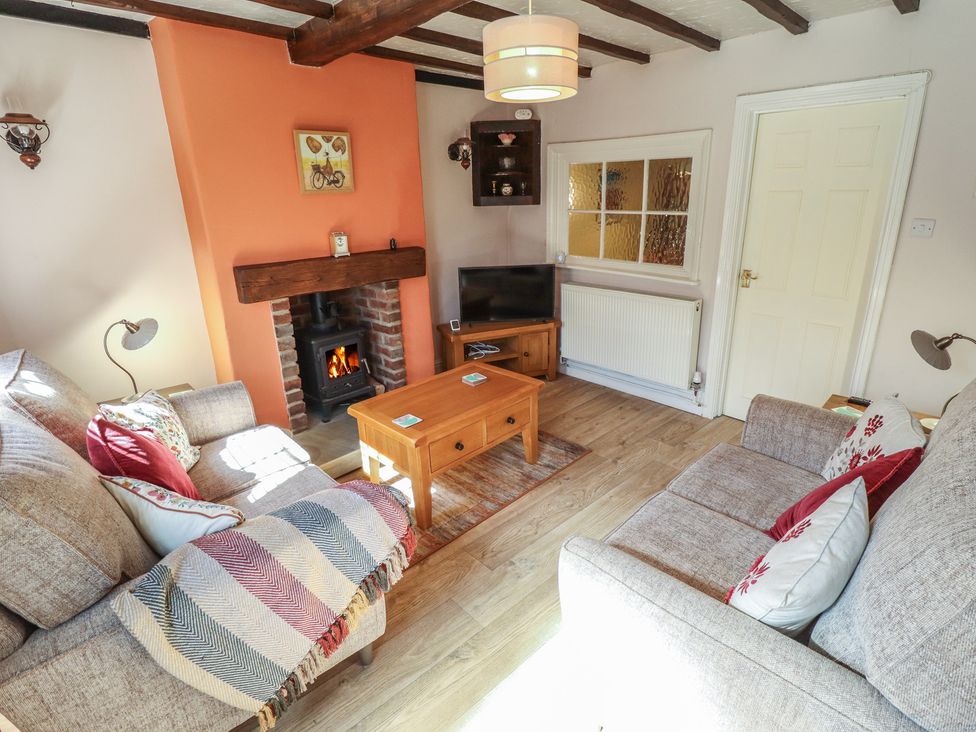 A living room with a sofa and fireplace at 29 High Street, Aldeburgh