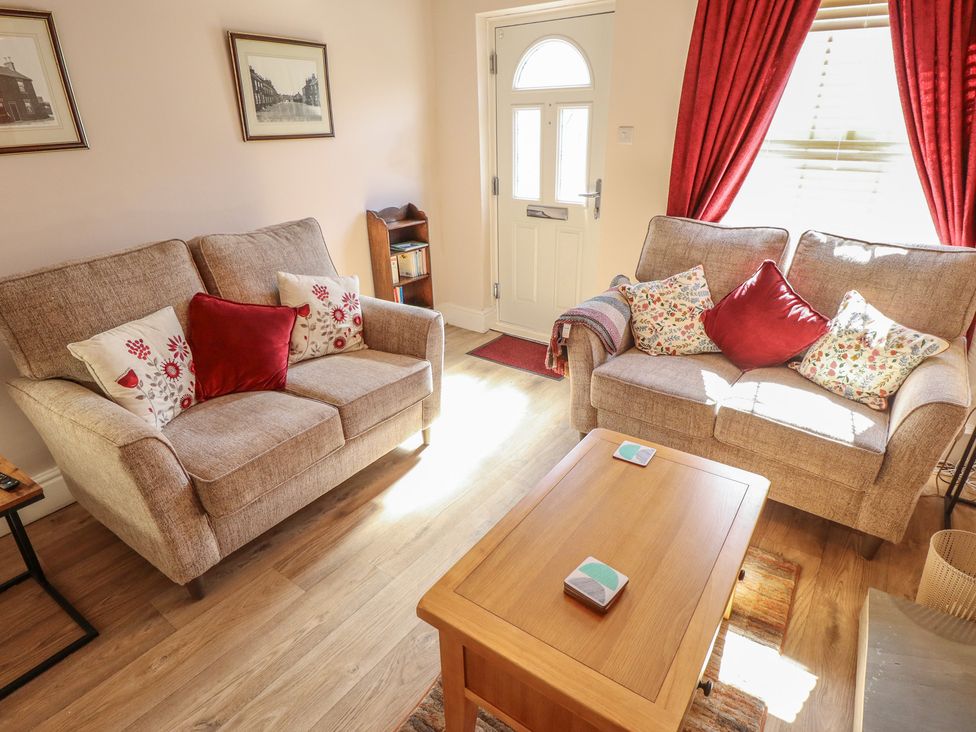 A living room with two sofas and a coffee table at 29 High Street in Aldeburgh