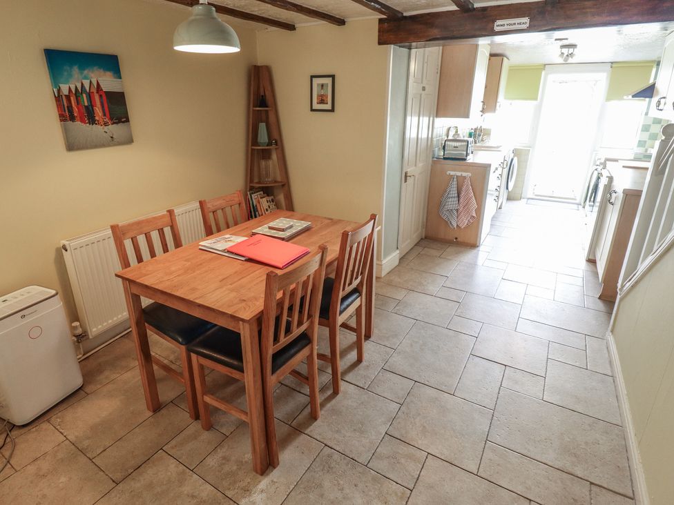 A dining area with a table and chairs at 29 High Street in Aldeburgh