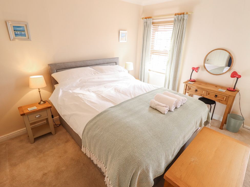 A bedroom with a bed and a desk at 29 High Street Aldeburgh