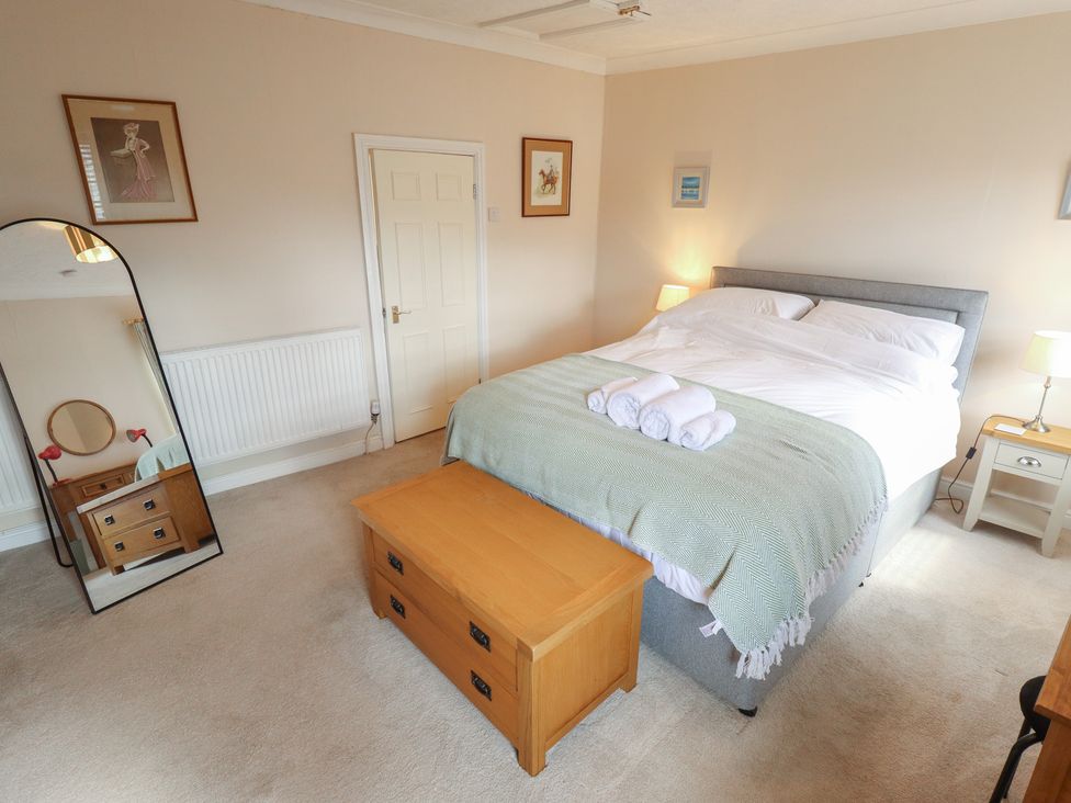 A bedroom with a double bed and bedside table at 29 High Street, Aldeburgh