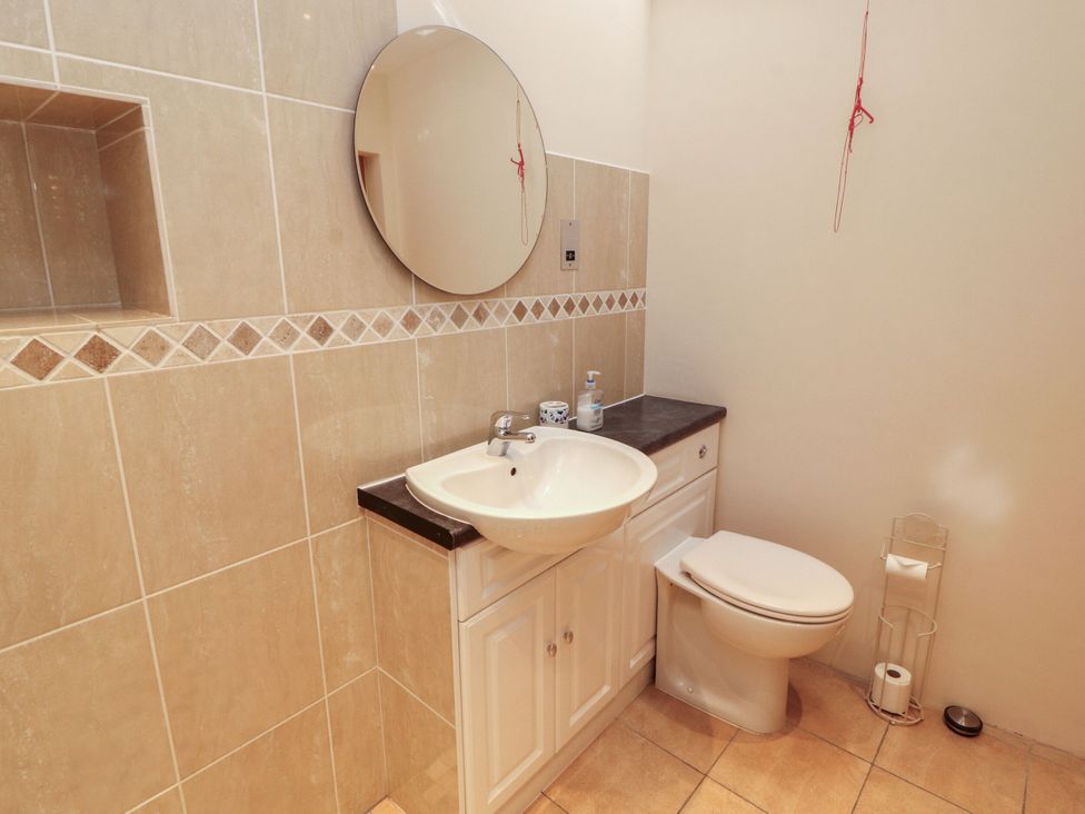 A bathroom with a sink and toilet at Sonya's Cottage in Anthorn, Solway Firth