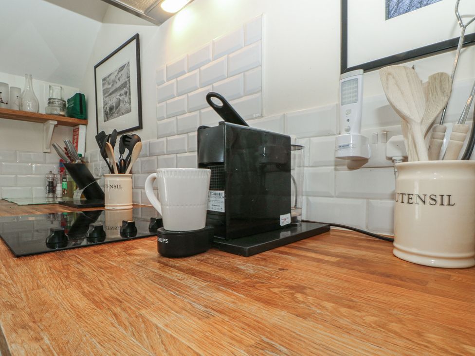 A kitchen with a coffee maker and utensils on a wooden countertop at The Hayloft Northop near Chester