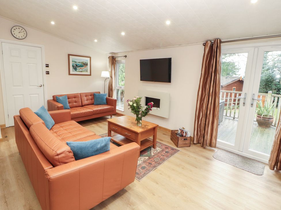 A living room with sofas and a television at Beech Hill Lodge (Beech Hill 9) at Fallbarrow Park, Bowness-on-Windermere