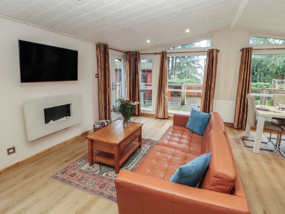 A living room with a sofa and television at Beech Hill Lodge (Beech Hill 9) at Fallbarrow Park, Bowness-on-Windermere