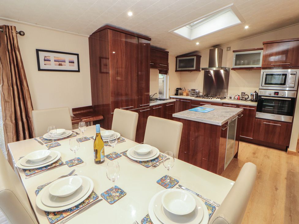A kitchen with a dining table set for a meal at Beech Hill Lodge (Beech Hill 9) at Fallbarrow Park