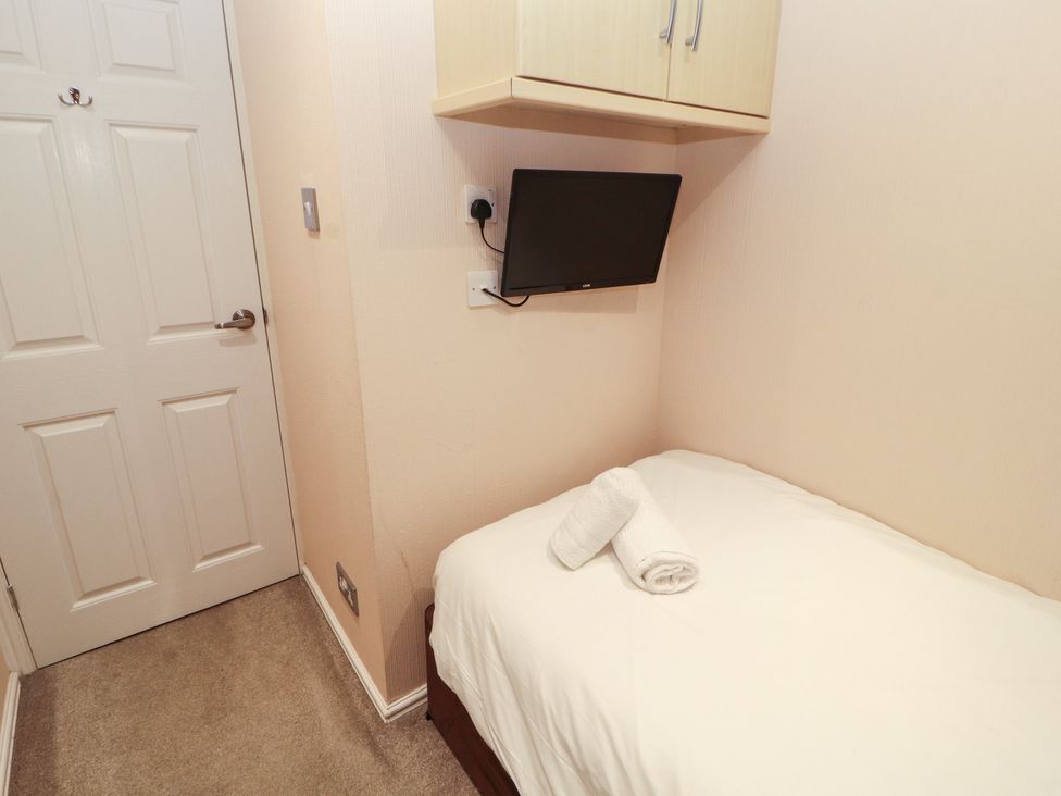 A bedroom with a bed and television at Beech Hill Lodge (Beech Hill 9) at Fallbarrow Park, Bowness-on-Windermere