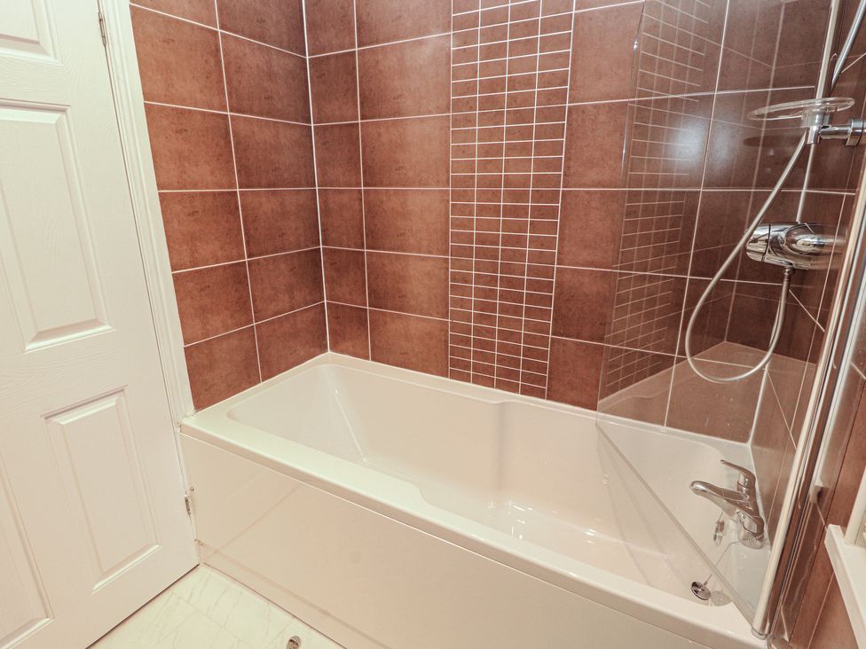 A bathroom with a bathtub and shower at Beech Hill Lodge (Beech Hill 9) at Fallbarrow Park, Bowness-on-Windermere