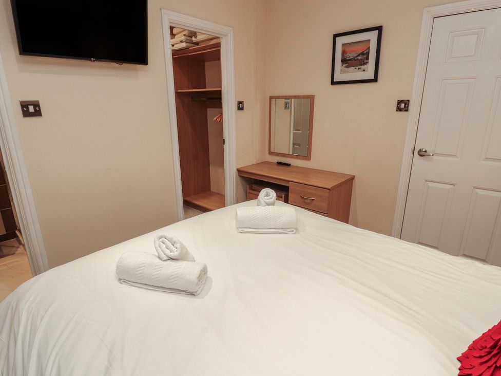 A bedroom with a bed and towels on top at Beech Hill Lodge (Beech Hill 9) at Fallbarrow Park, Bowness-on-Windermere
