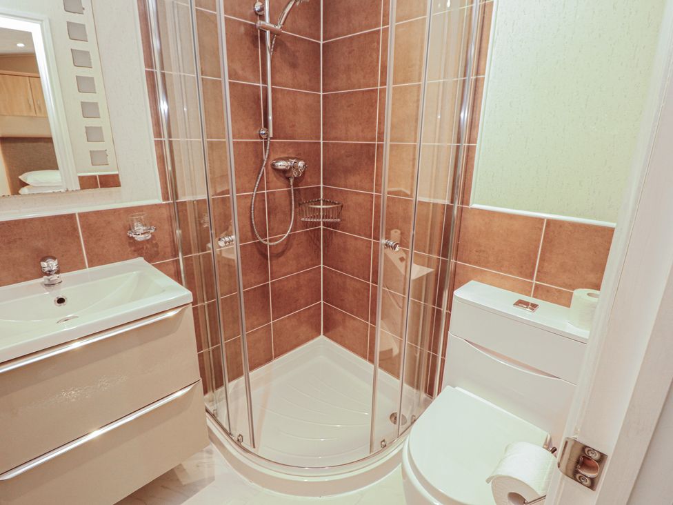 A bathroom featuring a shower, sink, and toilet at Beech Hill Lodge (Beech Hill 9) at Fallbarrow Park