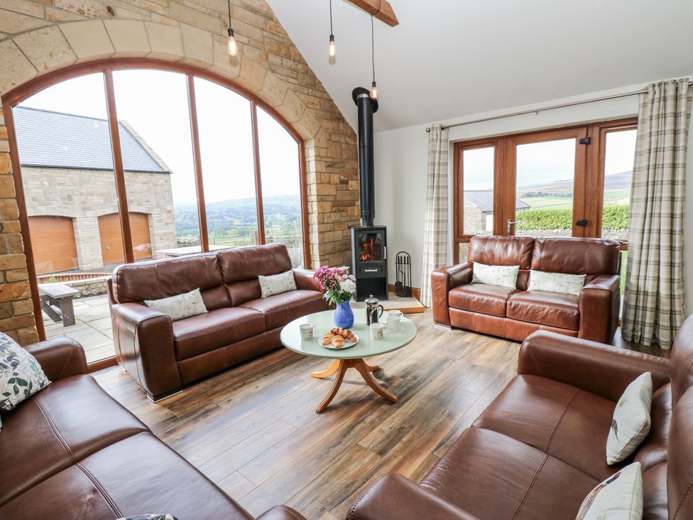 A living room with sofas and a fireplace at Jacob's Lodge in Eggleston