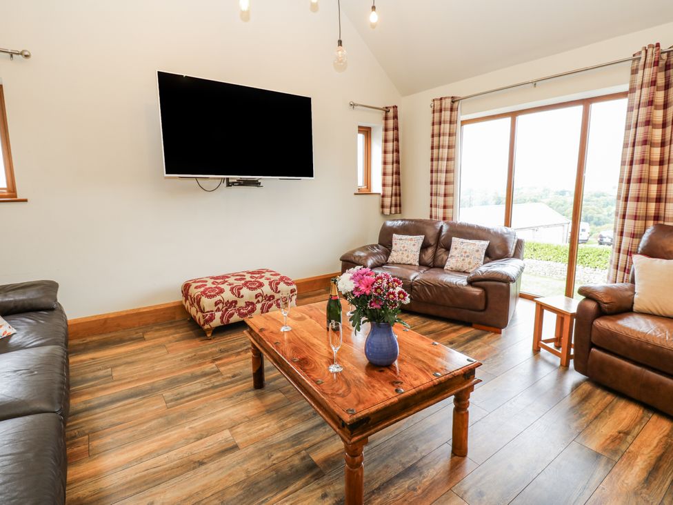 A living room with a television and coffee table at Jacob's Lodge in Eggleston
