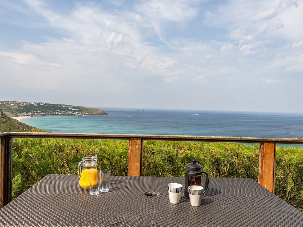 A table with drinks overlooking the sea at Cragford Sennen Cove