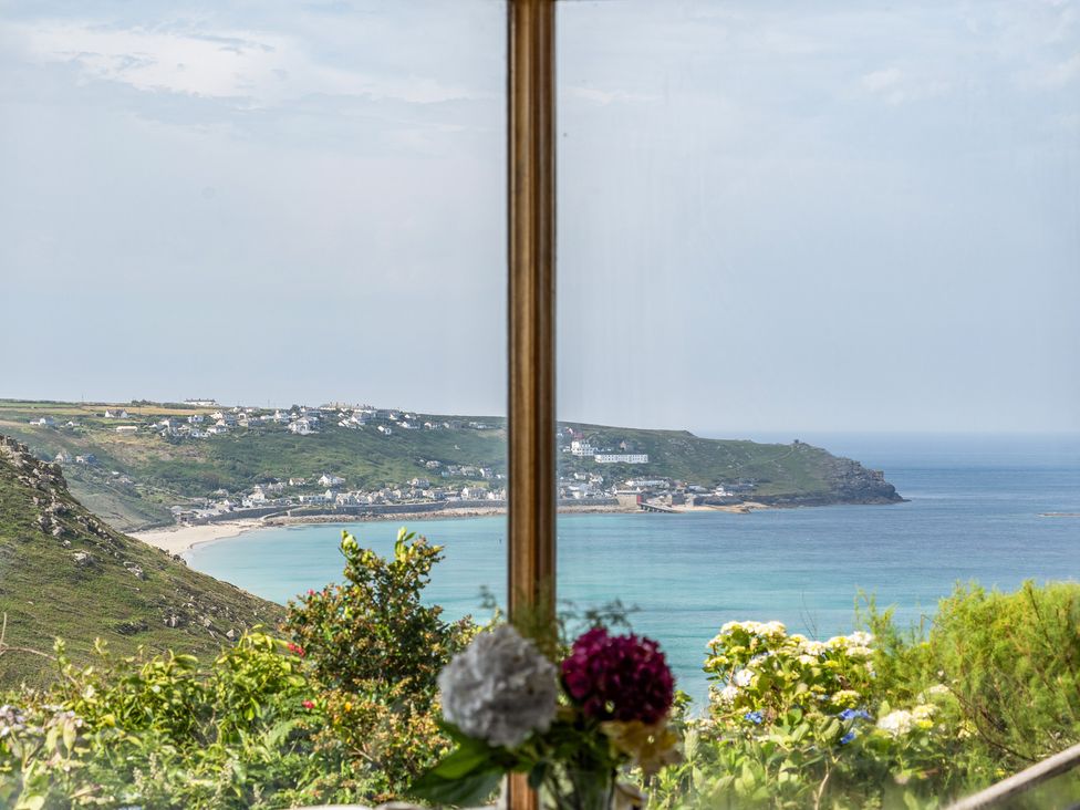 A view of the coastline and sea from a window at Cragford in Sennen Cove