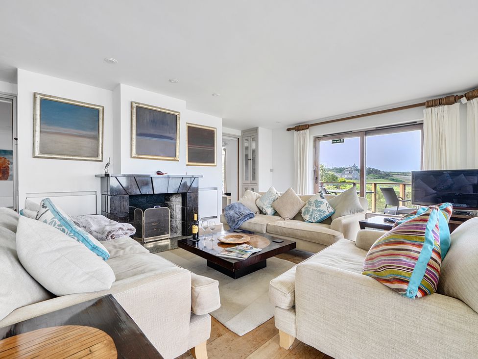 A living room with a sofa and a coffee table at Cragford in Sennen Cove