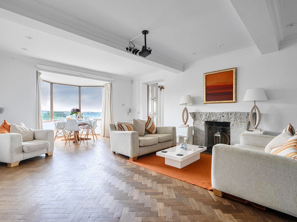 A living room with a sofa and coffee table at Cragford in Sennen Cove