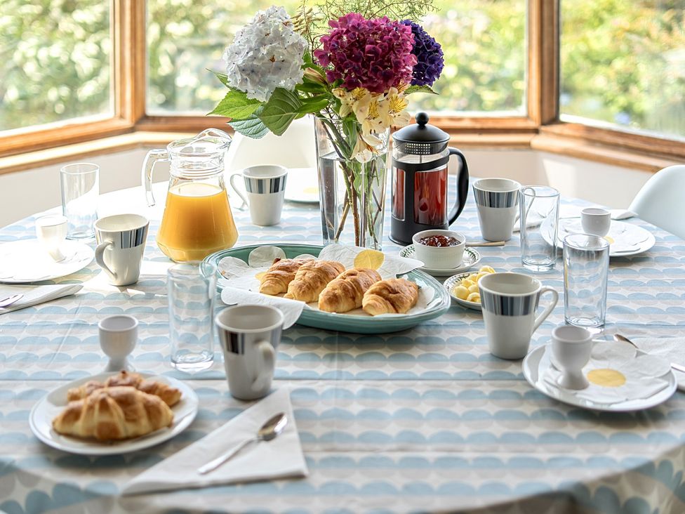 A dining table set with breakfast items at Cragford in Sennen Cove